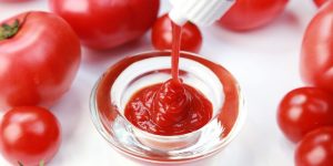 ketchup being poured into a dish. Ingredients of ketchup.