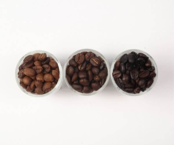 Keurig strong button works with any type of coffee roast. This is an image of 3 different types of roasted coffee beans.