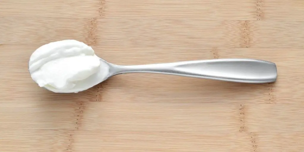 Image of a spoon with yogurt in it. There are many reasons to include yogurt in a smoothie, but if you need a substitute for yogurt in smoothies, there are options in this article.