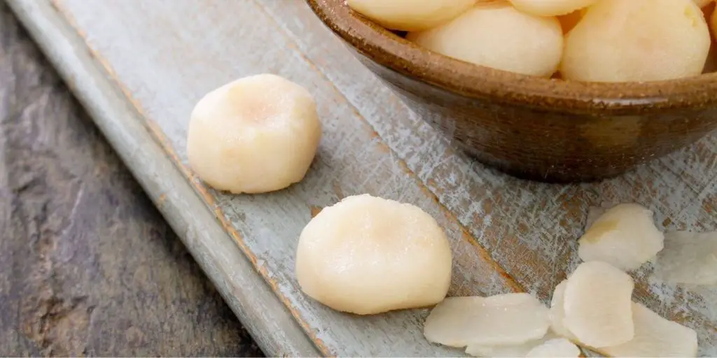 image of sliced water chestnut. Water chestnuts are firm, crunchy and have a very neutral flavor, taking on the flavor of foods it is cooked with