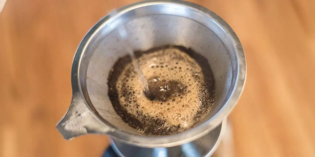 pour over coffee using dedicated metal sieve