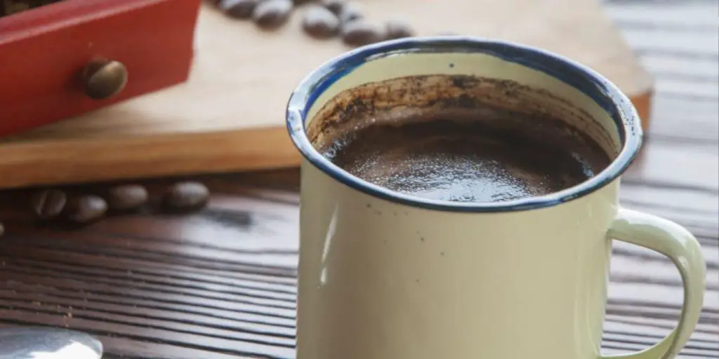 close up of mug of kopi tubruk style coffee