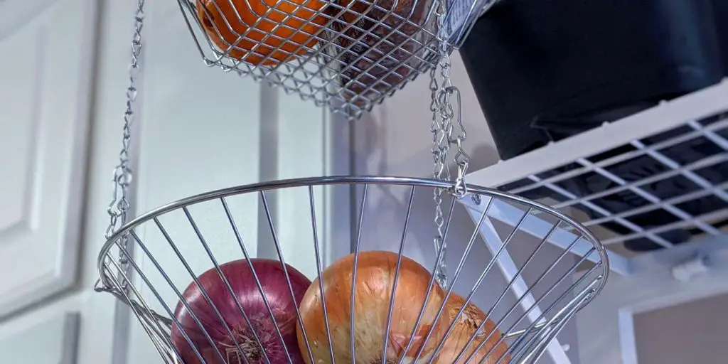 hanging tiered fruit basket can help organize small kitchens without a pantry.