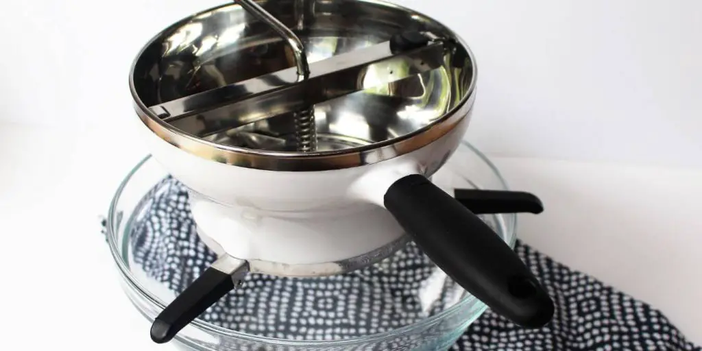 food mill placed on top of a bowl
