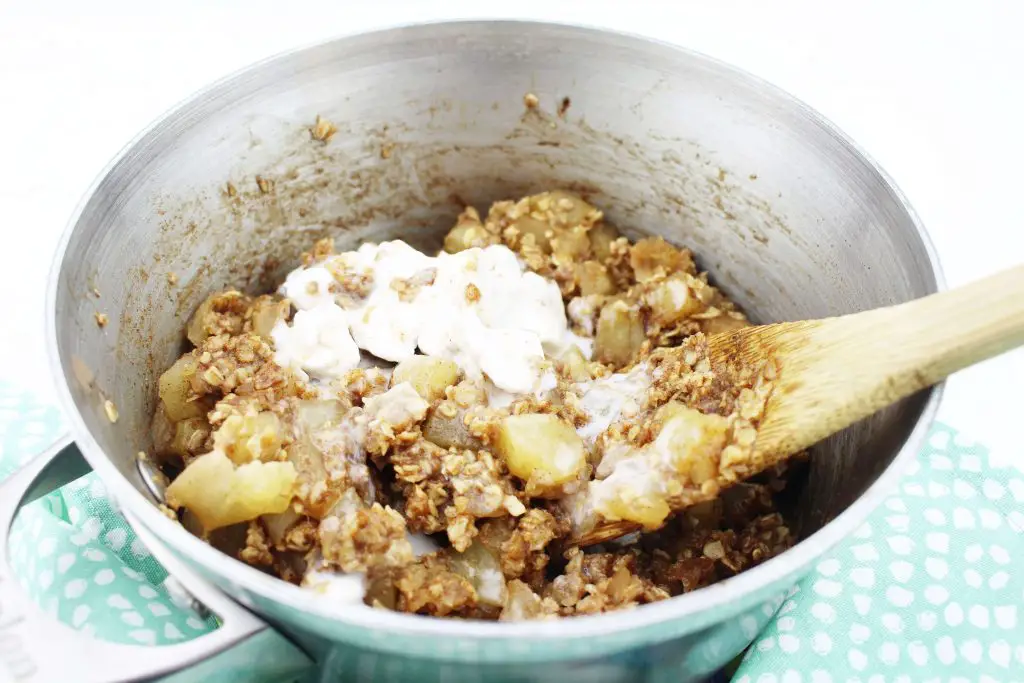 coconut cream being added to apple oatmeal