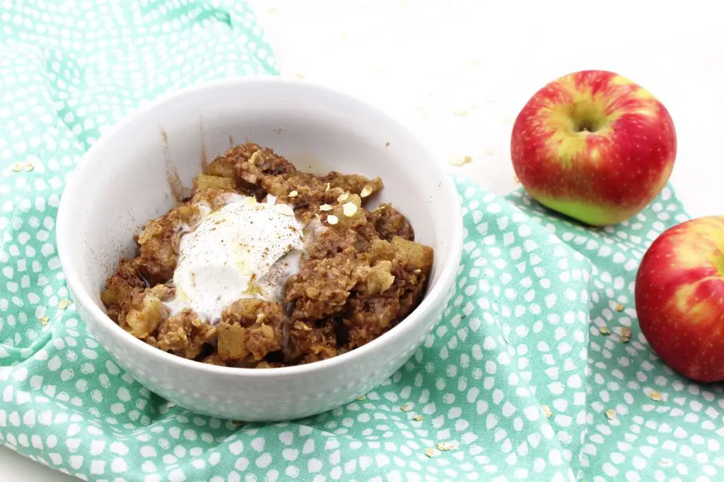 apple oatmeal in a bowl with fresh apples